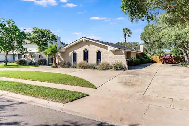5241 Saint Andrews Dr, Corpus Christi, TX 78413 - view of front of home featuring driveway, a chimney, and brick siding