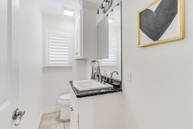 5241 Saint Andrews Dr, Corpus Christi, TX 78413 - bathroom featuring vanity, toilet, baseboards, and plenty of natural light