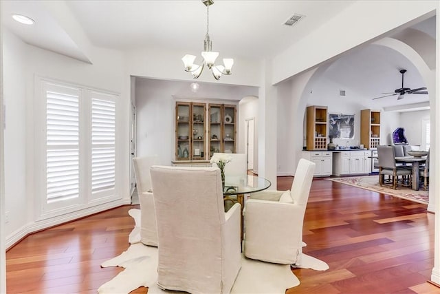 5241 Saint Andrews Dr, Corpus Christi, TX 78413 - dining area featuring a chandelier, arched walkways, wood finished floors, and ceiling fan