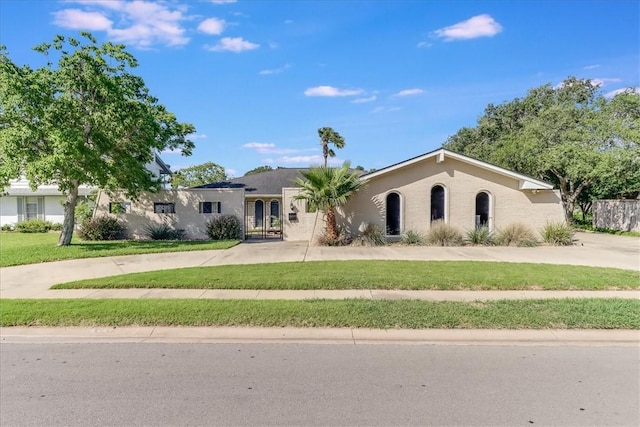 5241 Saint Andrews Dr, Corpus Christi, TX 78413 - single story home featuring curved driveway and a front lawn