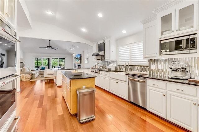 5241 Saint Andrews Dr, Corpus Christi, TX 78413 - kitchen with stainless steel appliances, lofted ceiling, a ceiling fan, white cabinets, and a sink