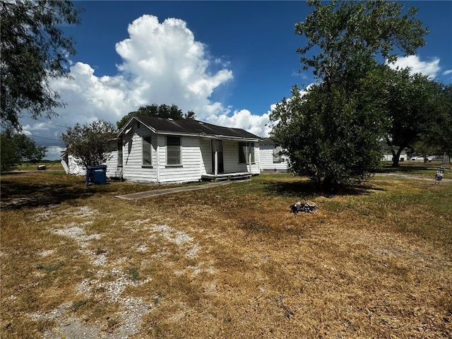 view of property exterior with a lawn