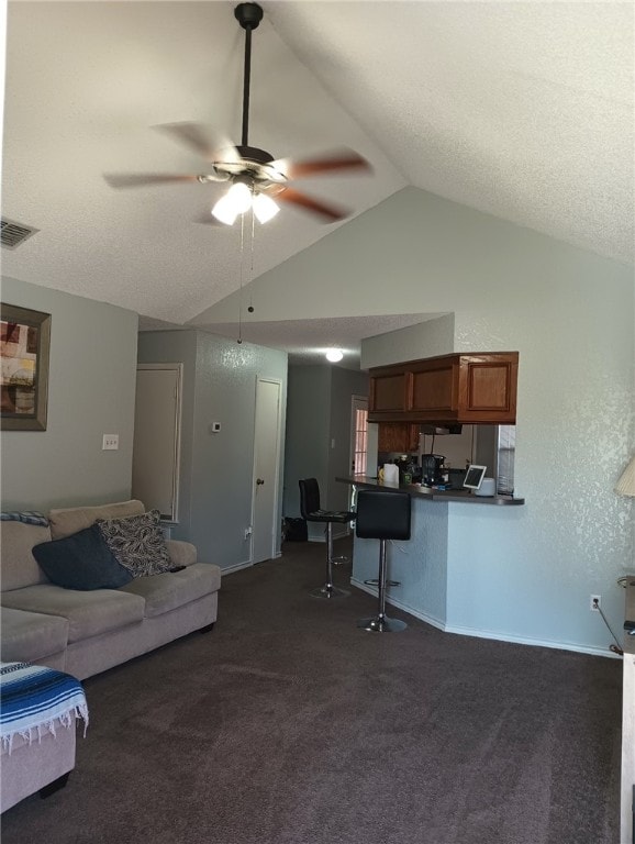 living room with lofted ceiling, dark carpet, a textured ceiling, and ceiling fan