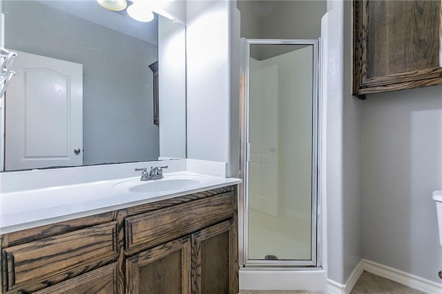 bathroom featuring vanity, toilet, and walk in shower