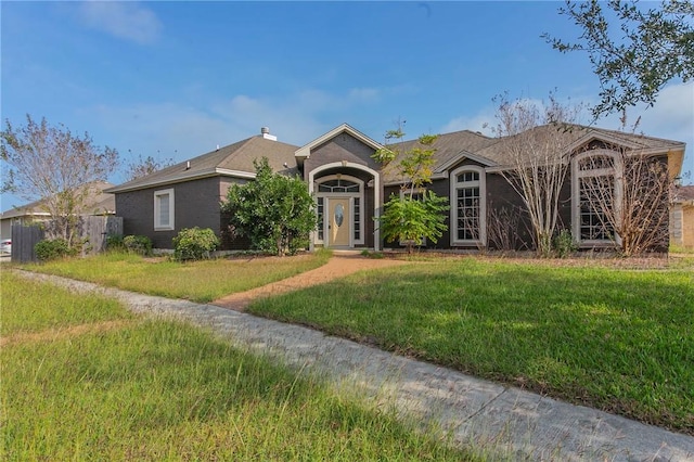 ranch-style home featuring a front yard