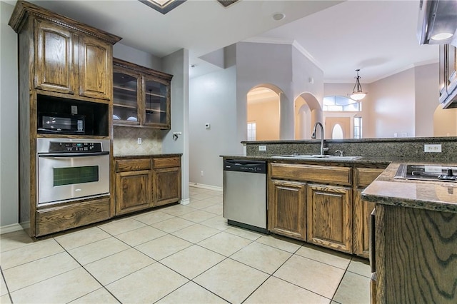 kitchen with sink, crown molding, decorative backsplash, light tile patterned floors, and stainless steel appliances