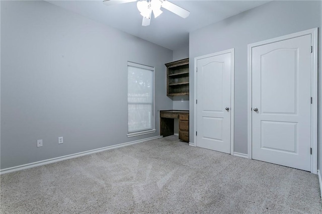 unfurnished bedroom featuring ceiling fan and light carpet