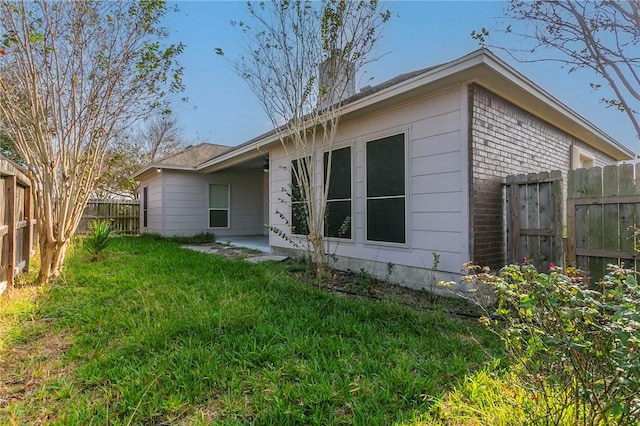 back of house with a yard