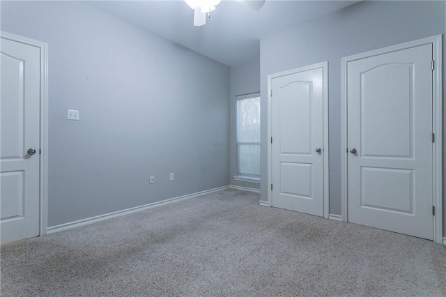 unfurnished bedroom featuring light colored carpet and ceiling fan