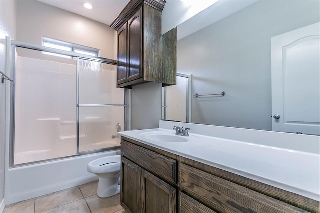 full bathroom featuring shower / bath combination with glass door, vanity, toilet, and tile patterned flooring