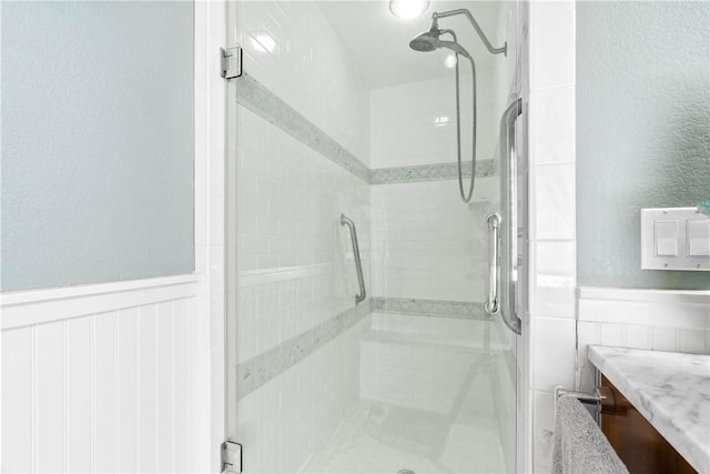 110 Bayshore Dr, Ingleside, TX 78362 - bathroom featuring a shower stall, a wainscoted wall, and vanity