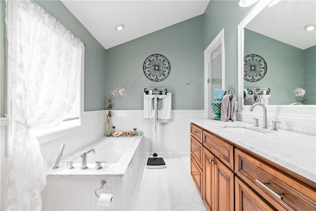 110 Bayshore Dr, Ingleside, TX 78362 - full bath with vanity, a wainscoted wall, a bath, and lofted ceiling