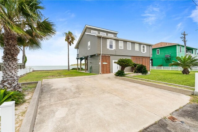 110 Bayshore Dr, Ingleside, TX 78362 - view of front of house with driveway and a garage