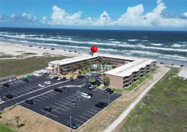 aerial view with a water view and a beach view