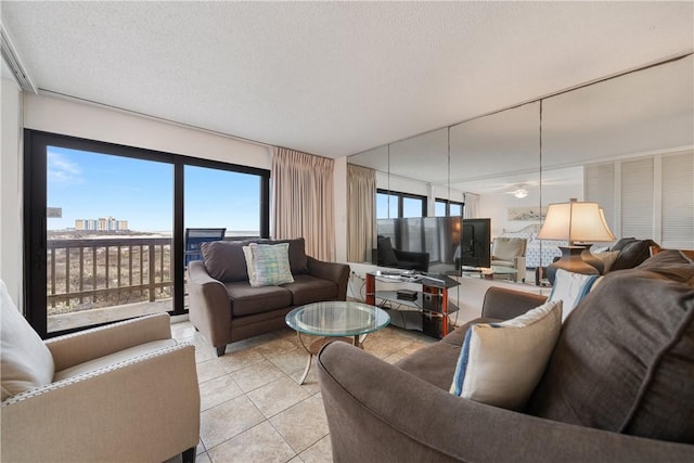 living room with a textured ceiling and light tile patterned floors