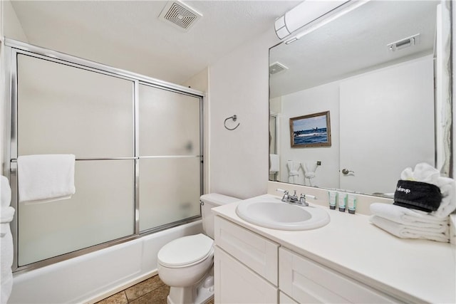 full bathroom with vanity, toilet, enclosed tub / shower combo, and tile patterned floors