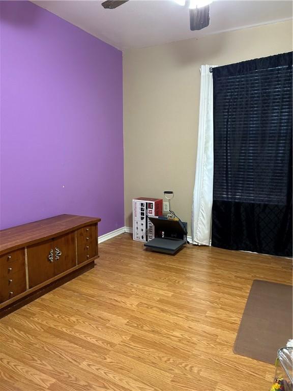 10544 Saddle, Corpus Christi, TX 78410 - unfurnished room featuring a ceiling fan, wood finished floors, and baseboards