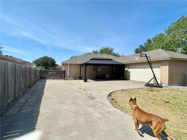 exterior space with a garage and a lawn