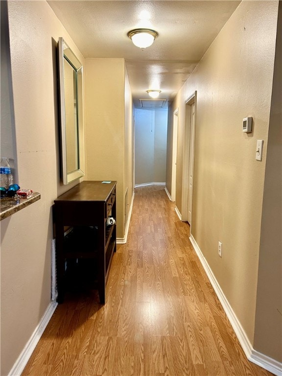 corridor with light hardwood / wood-style flooring