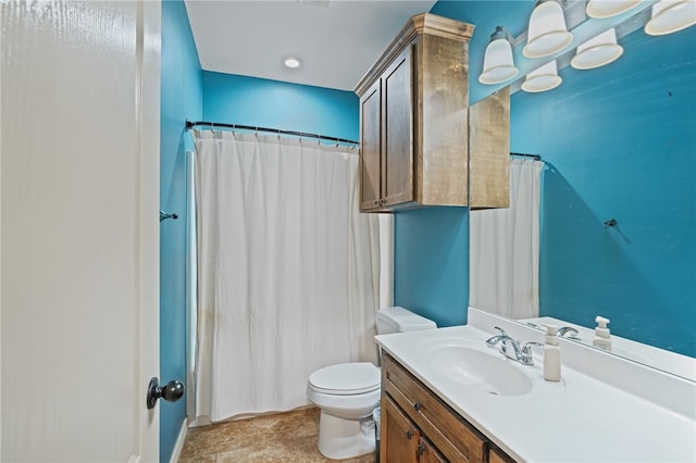 bathroom featuring curtained shower, vanity, and toilet