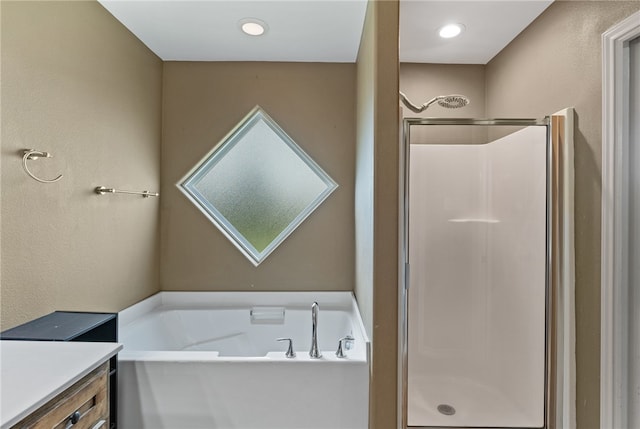 bathroom with shower with separate bathtub and vanity