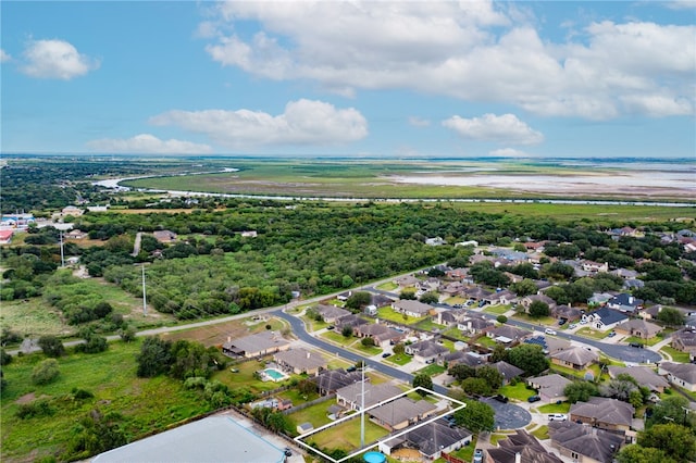 birds eye view of property featuring a beach view and a water view