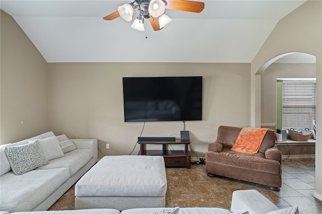 living room featuring lofted ceiling, tile patterned floors, and ceiling fan