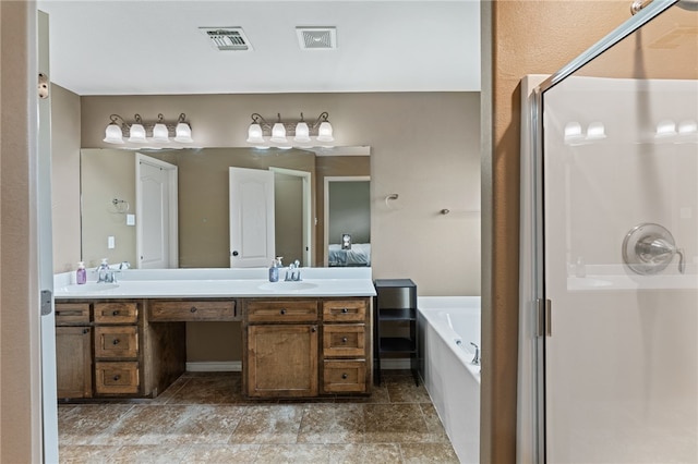 bathroom with vanity and independent shower and bath