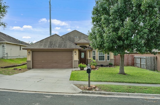 view of front of home with a front lawn and a garage