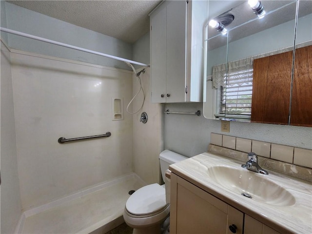 1662 Spicewood Dr, Corpus Christi, TX 78412 - bathroom featuring walk in shower, a textured ceiling, toilet, and vanity