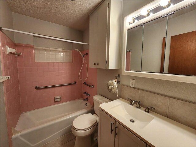 1662 Spicewood Dr, Corpus Christi, TX 78412 - full bathroom featuring a textured ceiling, vanity, washtub / shower combination, toilet, and tile patterned flooring