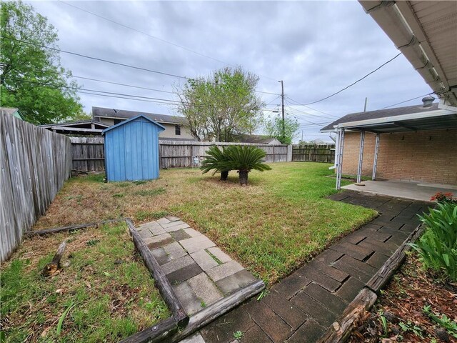 1662 Spicewood Dr, Corpus Christi, TX 78412 - view of yard featuring a fenced backyard, an outdoor structure, a patio, and a storage unit