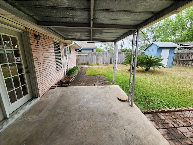 1662 Spicewood Dr, Corpus Christi, TX 78412 - view of patio / terrace featuring a storage unit, an outbuilding, and a fenced backyard