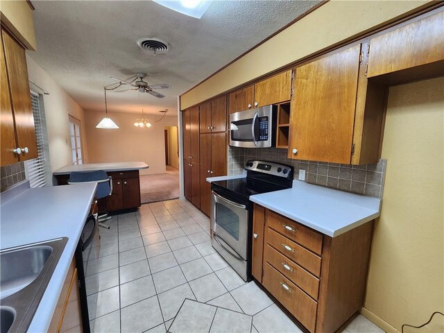 1662 Spicewood Dr, Corpus Christi, TX 78412 - kitchen with stainless steel appliances, a textured ceiling, a sink, and backsplash
