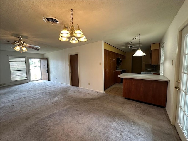 1662 Spicewood Dr, Corpus Christi, TX 78412 - kitchen with open floor plan, light countertops, light colored carpet, a peninsula, and visible vents