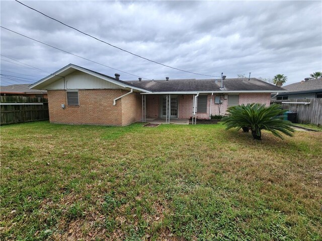 1662 Spicewood Dr, Corpus Christi, TX 78412 - rear view of property with fence, a lawn, french doors, and brick siding
