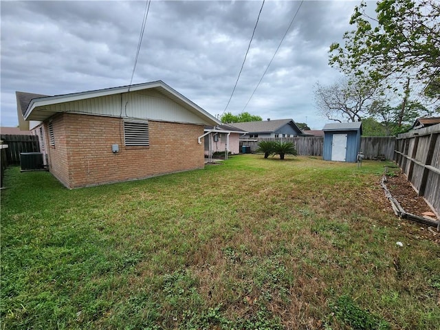 1662 Spicewood Dr, Corpus Christi, TX 78412 - view of yard featuring central air condition unit, an outdoor structure, a fenced backyard, and a storage shed