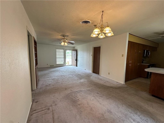 1662 Spicewood Dr, Corpus Christi, TX 78412 - unfurnished living room with light carpet, visible vents, and ceiling fan with notable chandelier