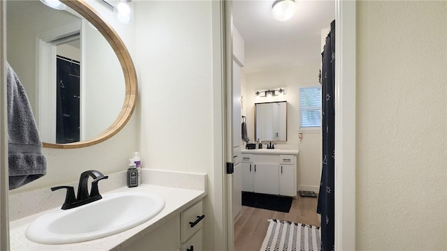 bathroom featuring vanity and hardwood / wood-style floors