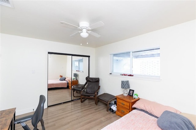 bedroom featuring ceiling fan, a closet, and light hardwood / wood-style floors