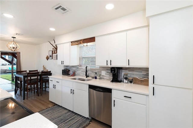 kitchen featuring pendant lighting, dishwasher, white cabinetry, sink, and backsplash