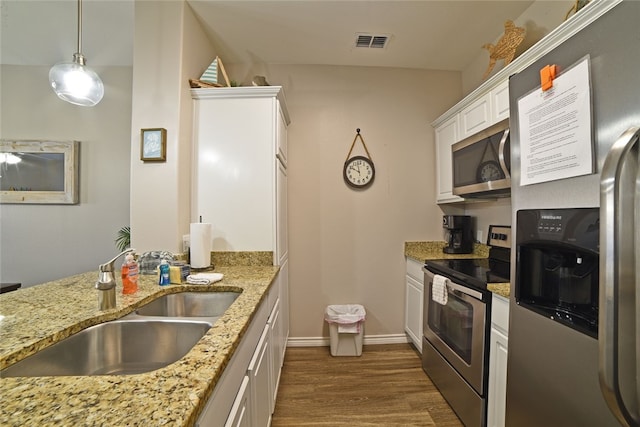 kitchen with stainless steel appliances, sink, pendant lighting, white cabinets, and dark hardwood / wood-style floors