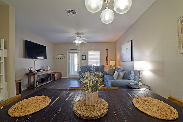 living room with dark hardwood / wood-style floors and ceiling fan