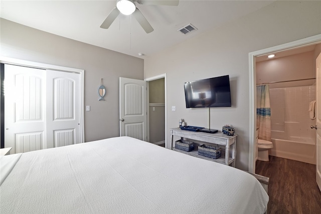 bedroom with dark hardwood / wood-style flooring, a closet, ceiling fan, and connected bathroom