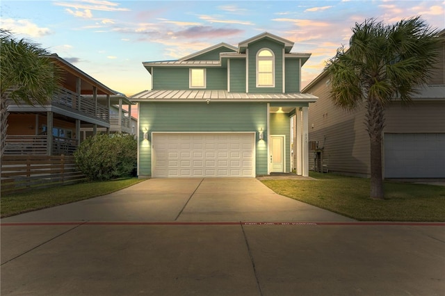 view of front facade featuring a garage and a lawn