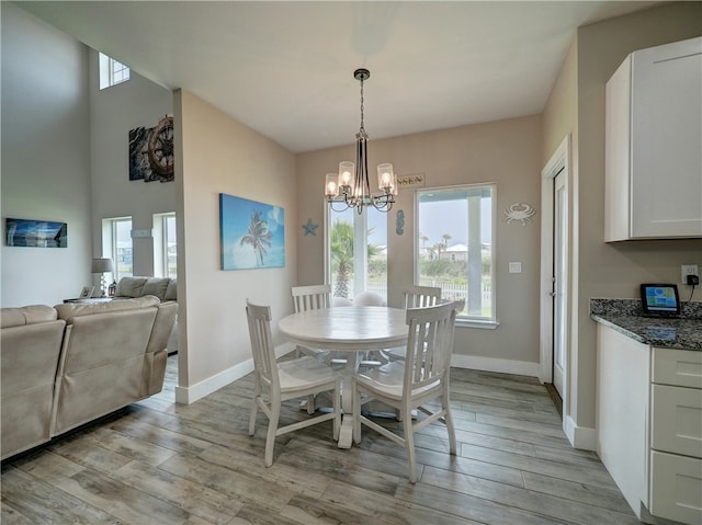 dining space featuring a chandelier and light wood-type flooring