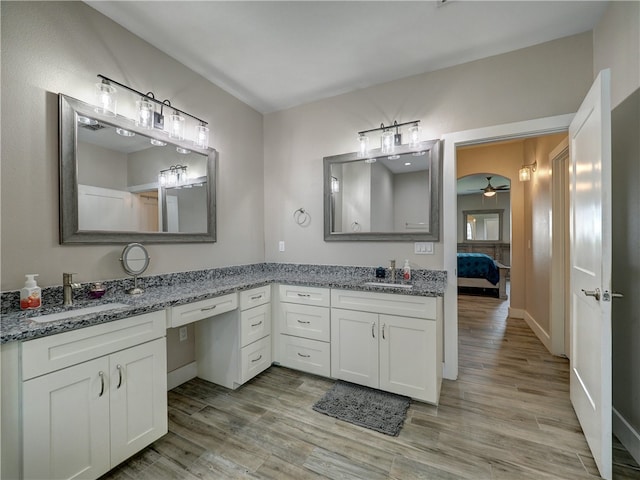 bathroom with ceiling fan, vanity, and wood-type flooring