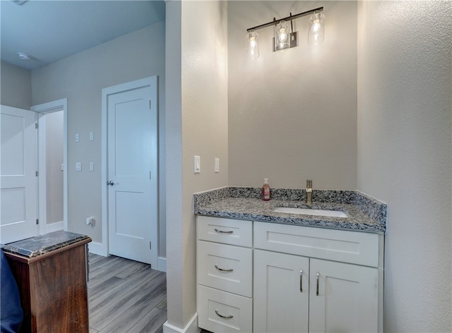 bathroom with hardwood / wood-style floors and vanity