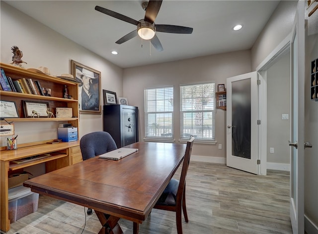 home office with ceiling fan, french doors, and light wood-type flooring