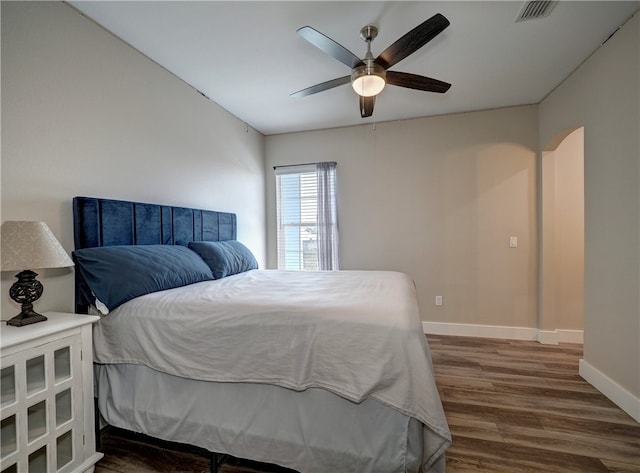 bedroom featuring ceiling fan and dark hardwood / wood-style flooring